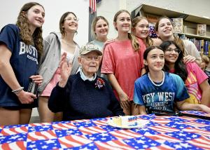 WWII veteran waves with group of middle school girls