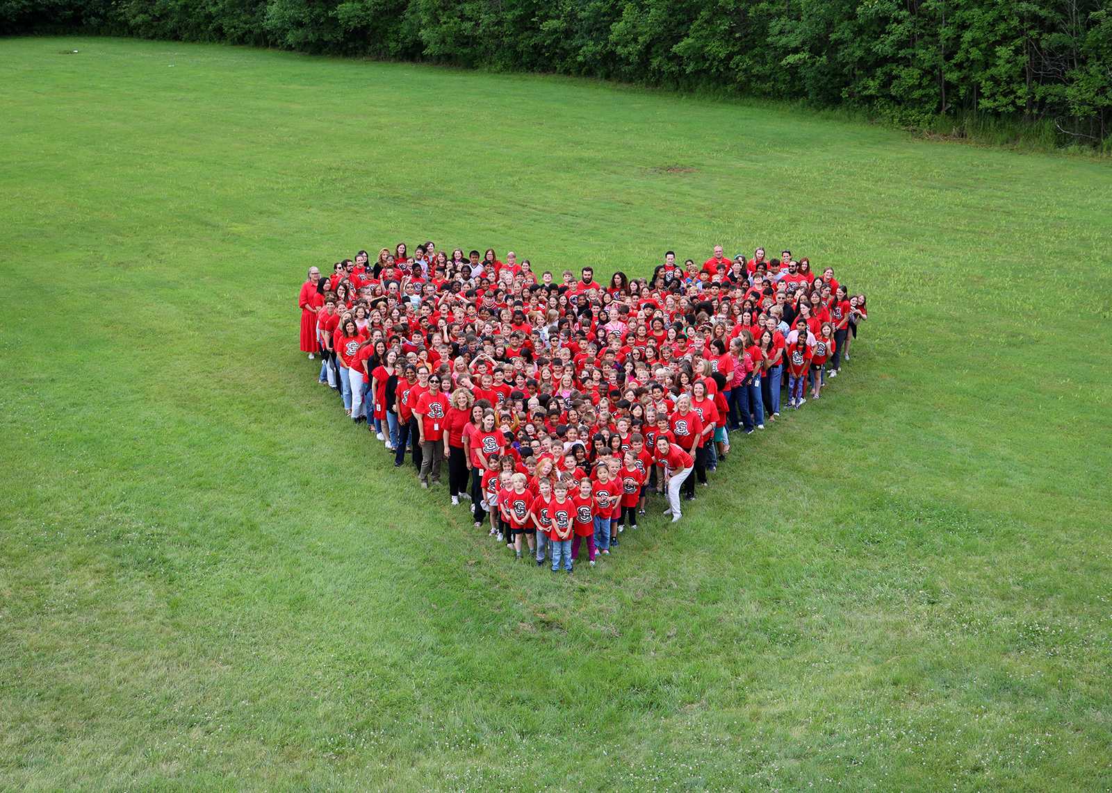 students in the shape of a heart from above