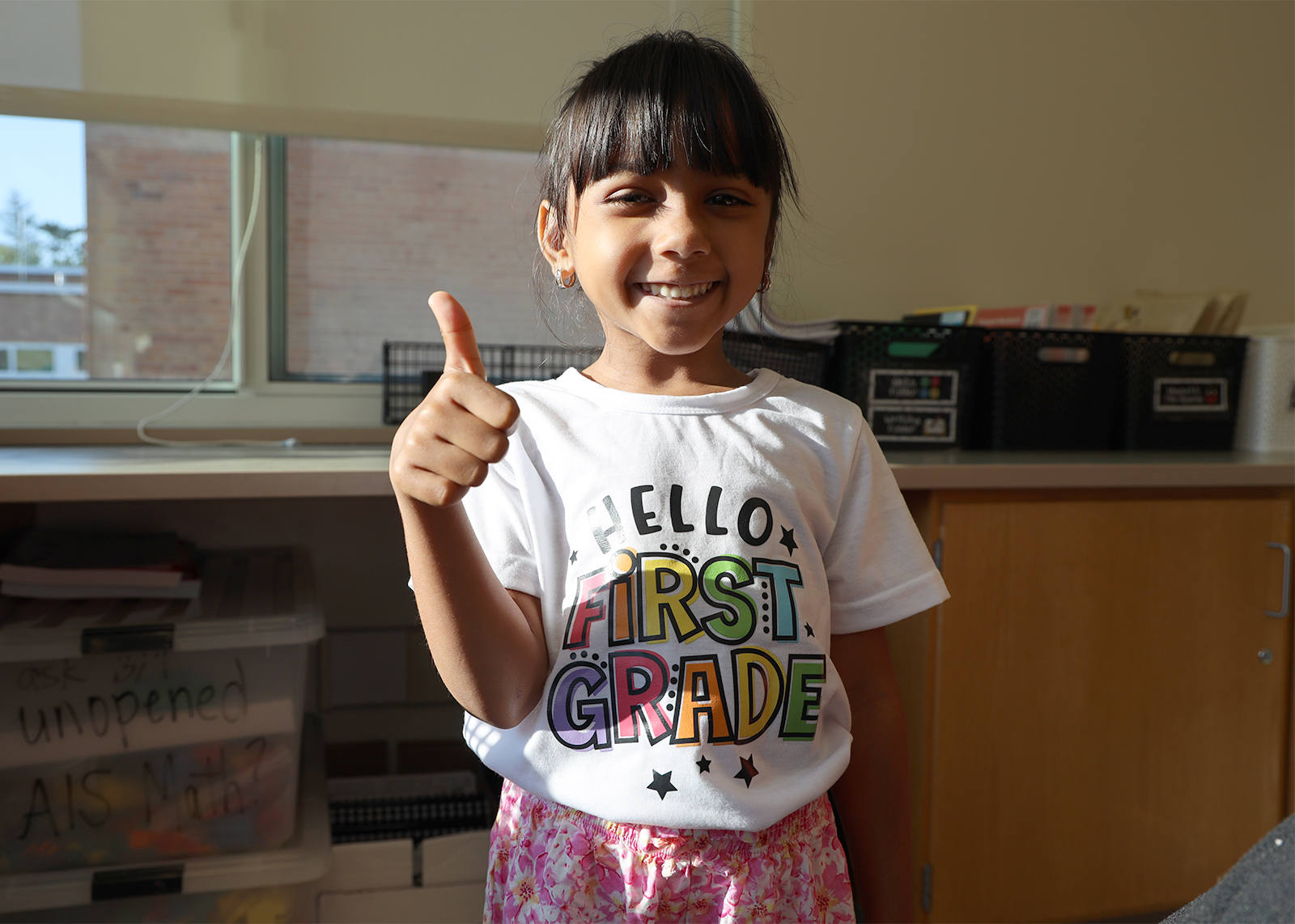 young students giving thumbs up