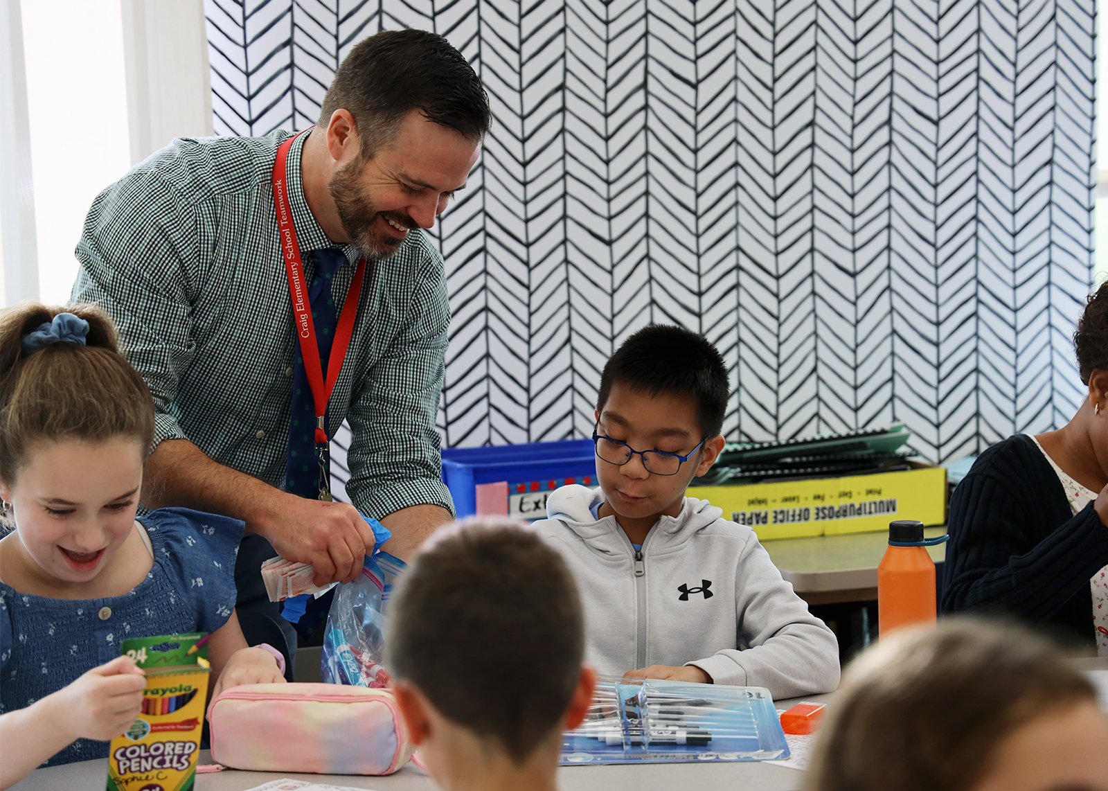 teacher smiling at student in class