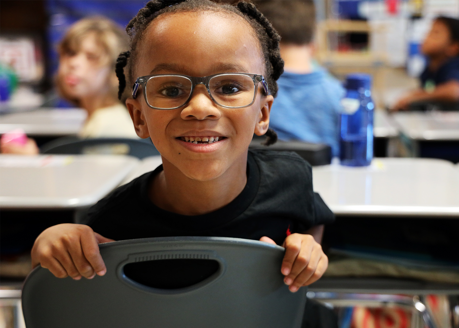 young student with glasses smiles