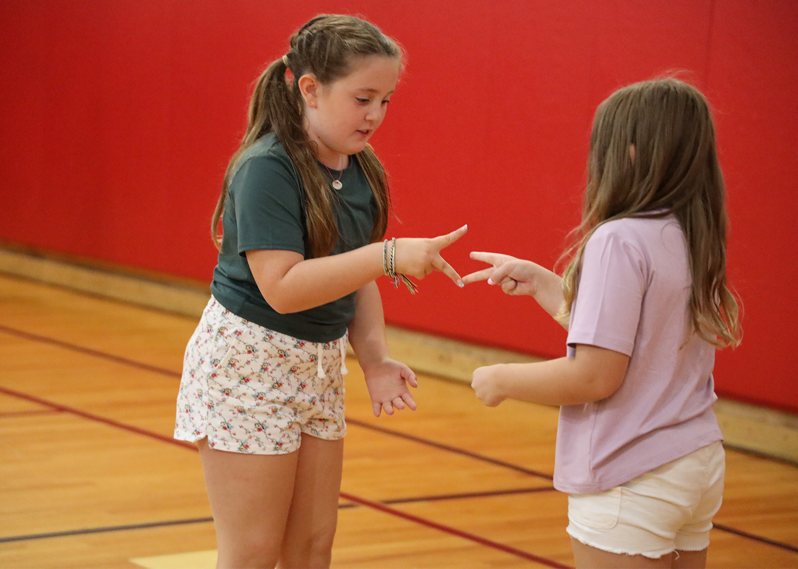 two students play rock, paper scissors