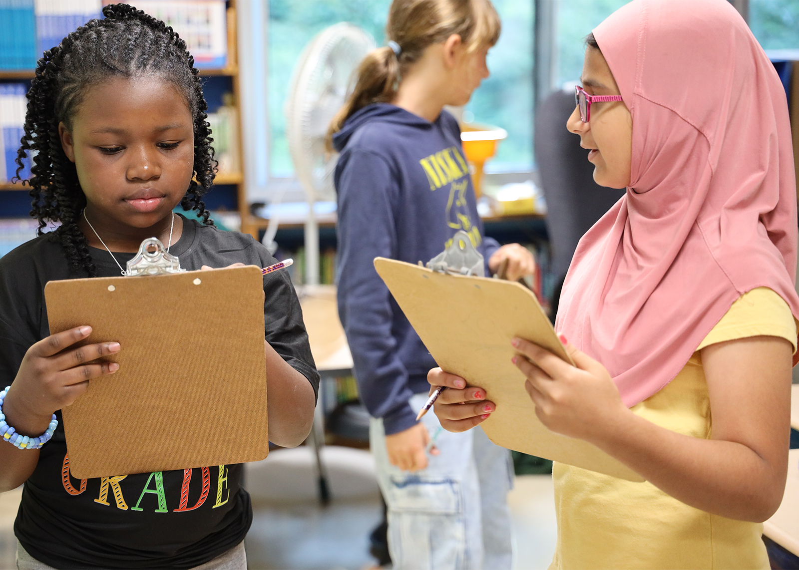 two students do a clipboard activity