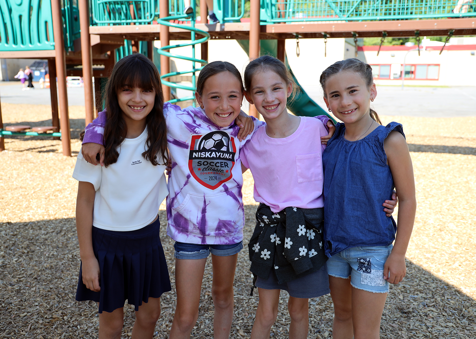 groups of young students smile at recess