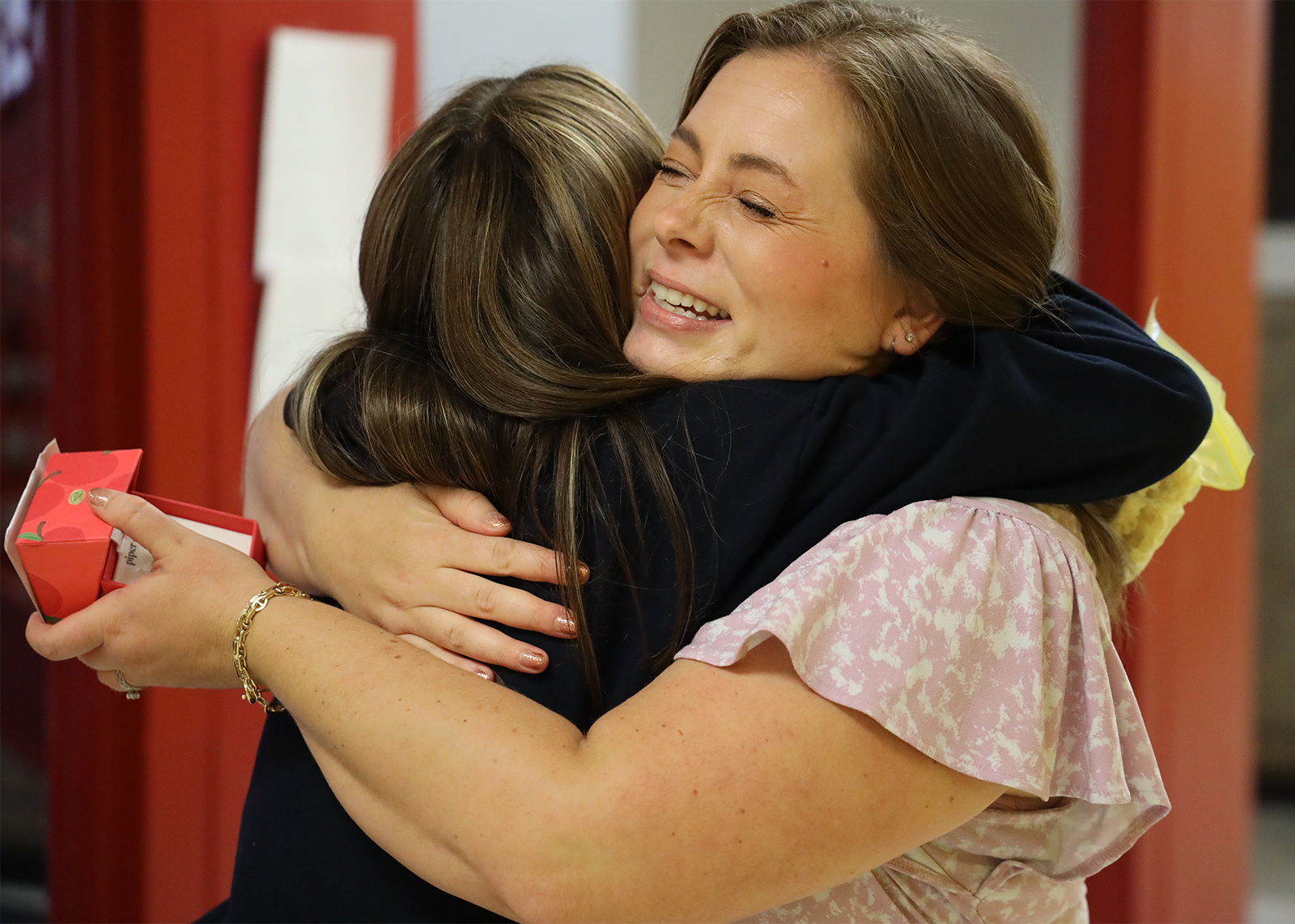 educators hugs a student