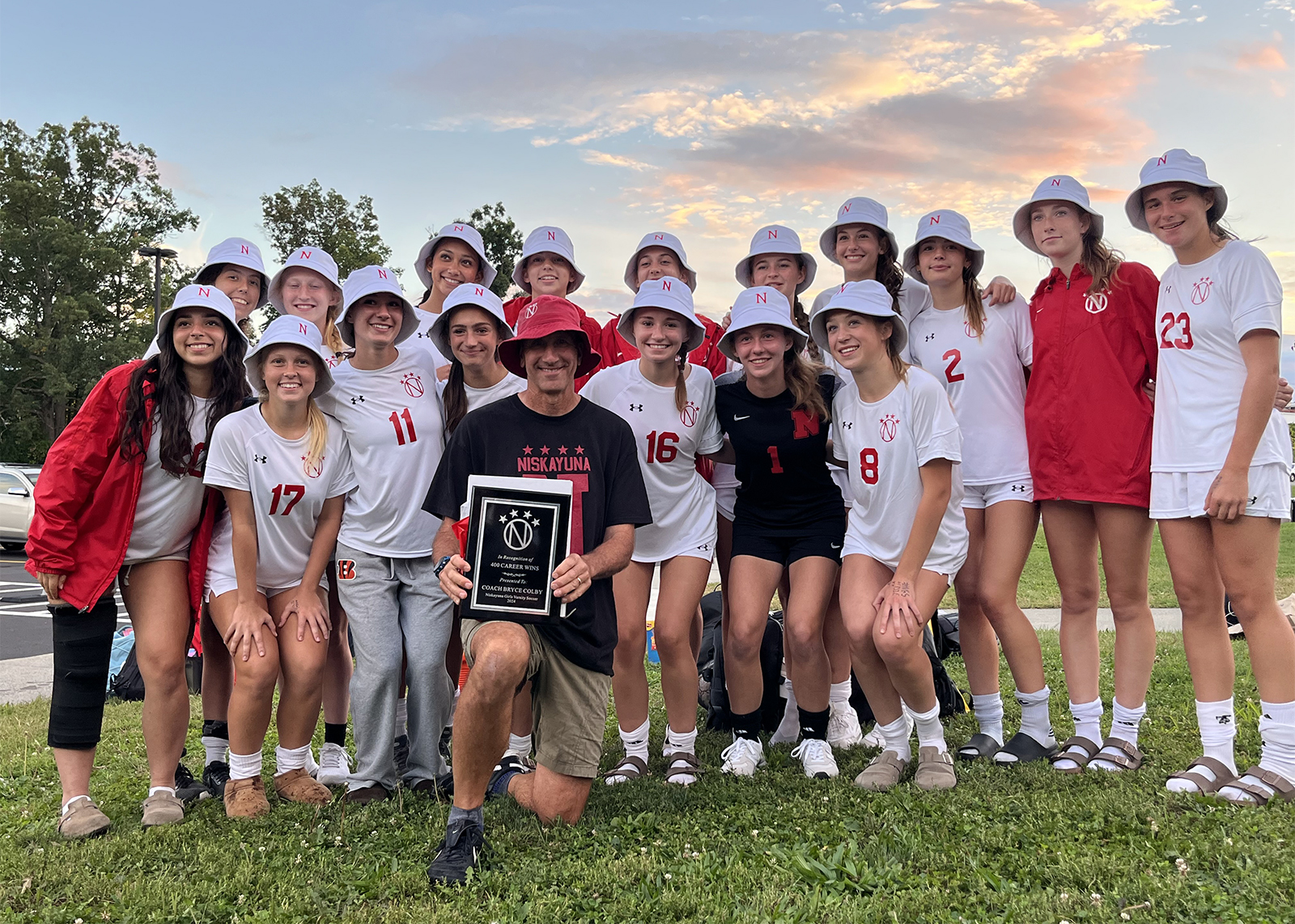 group of soccer players with coach all wearing buckets hats