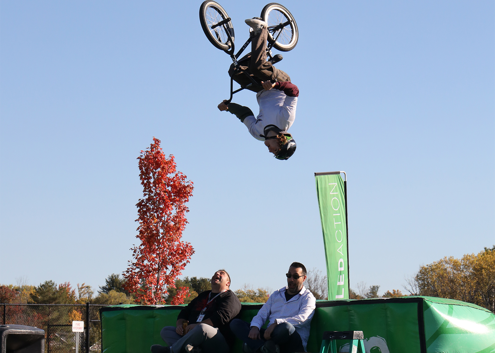 bmx bike flies over administrators sitting