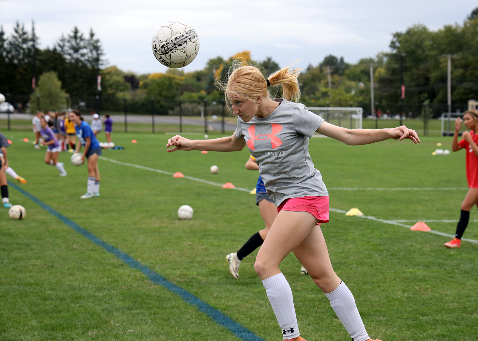 high school soccer player heading the ball