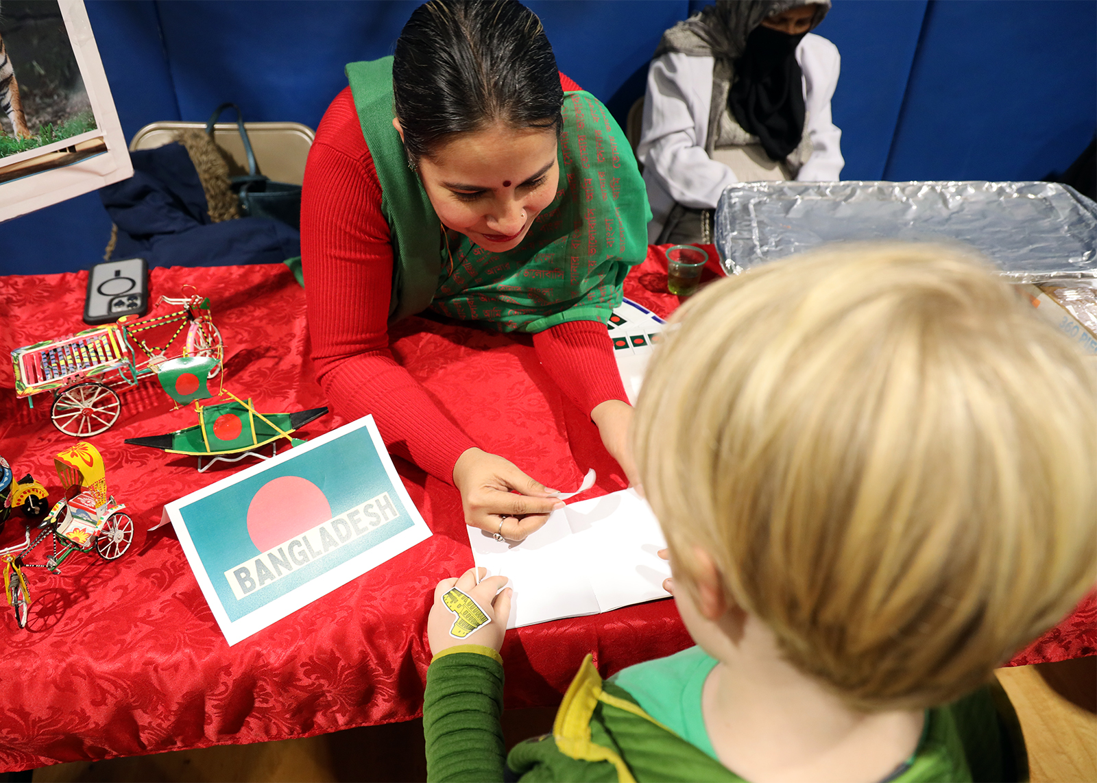 parent giving a passport sticker to student