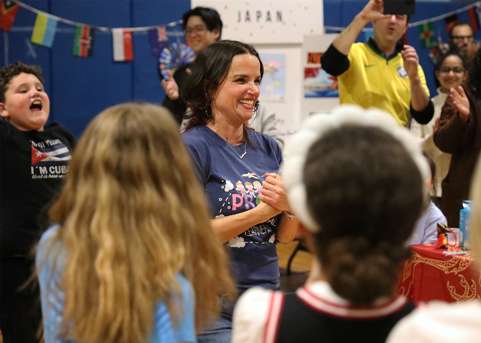 ENL teacher smiling in middle of multicultural night