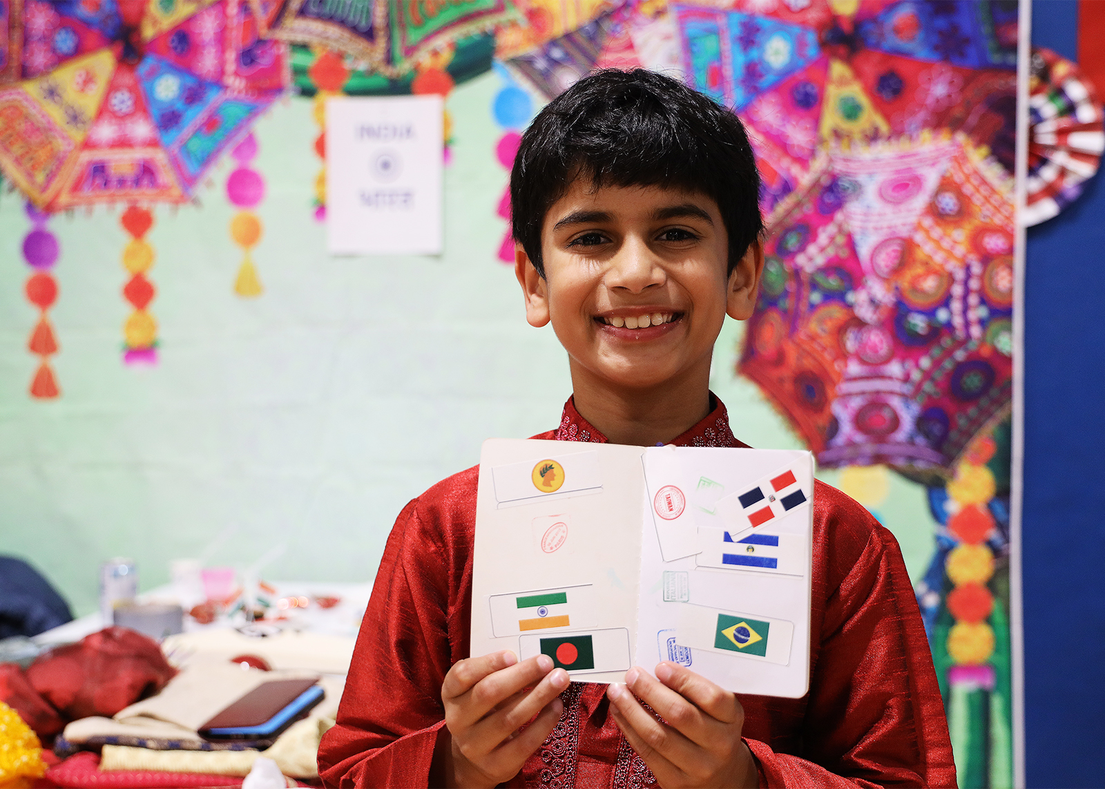 student smiles with pretend passport