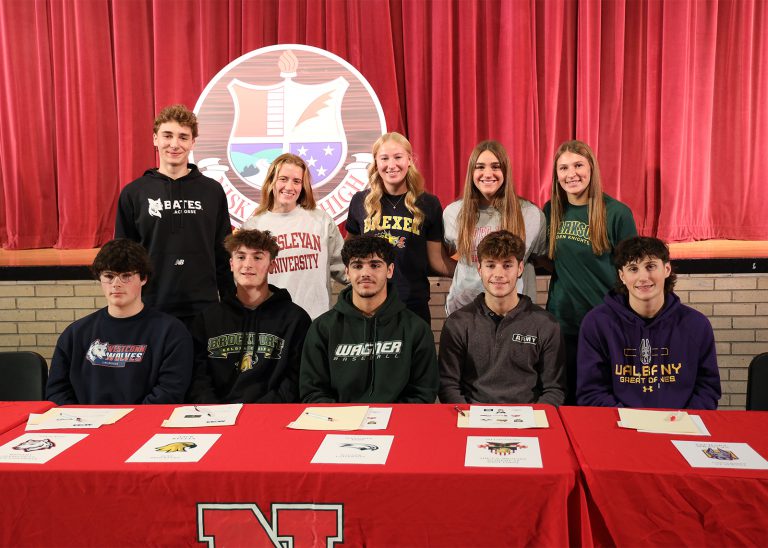 group of student-athlete smiling on signing day