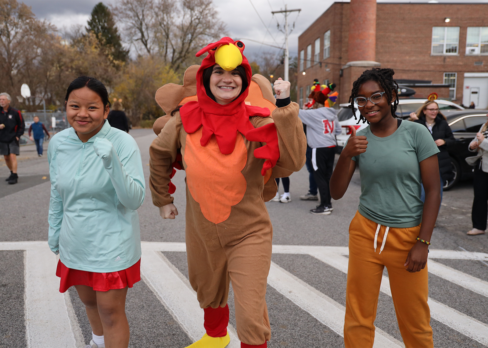 student lined up to run the turkey trot with teacher dressed as a turkey