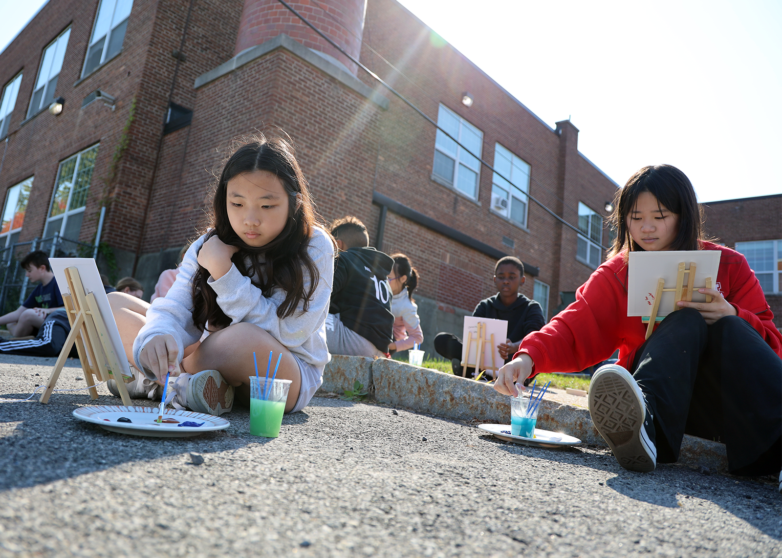 students painting outside