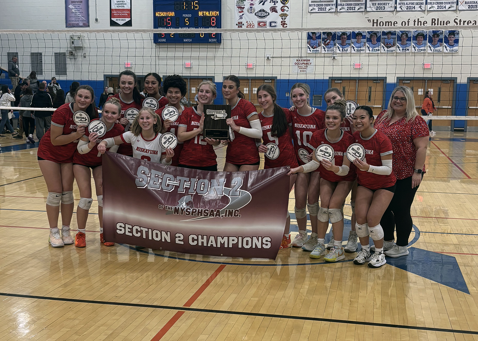 high school volleyball with section 2 championship banner