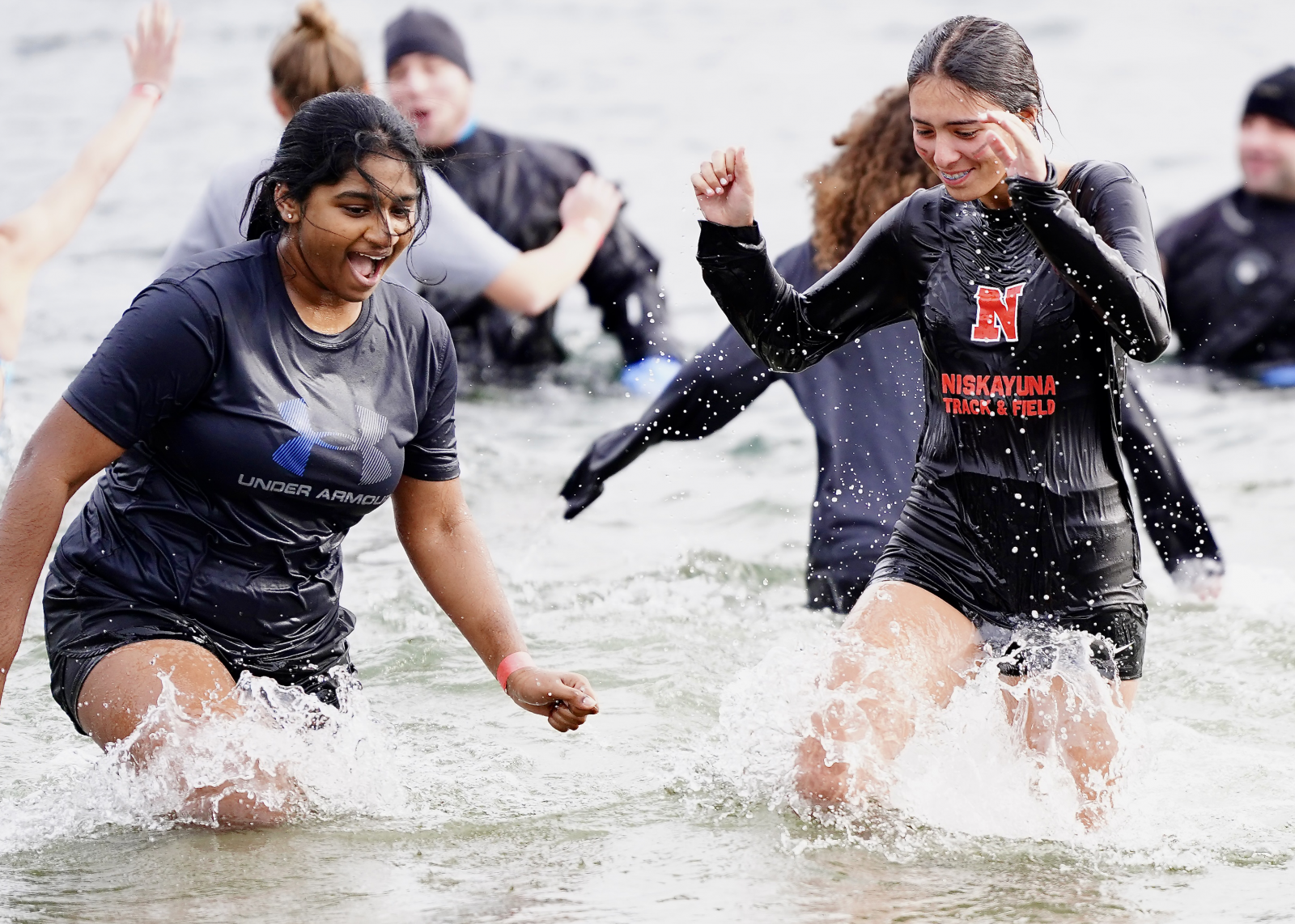 two nisky students in freezing cold water for polar plunge