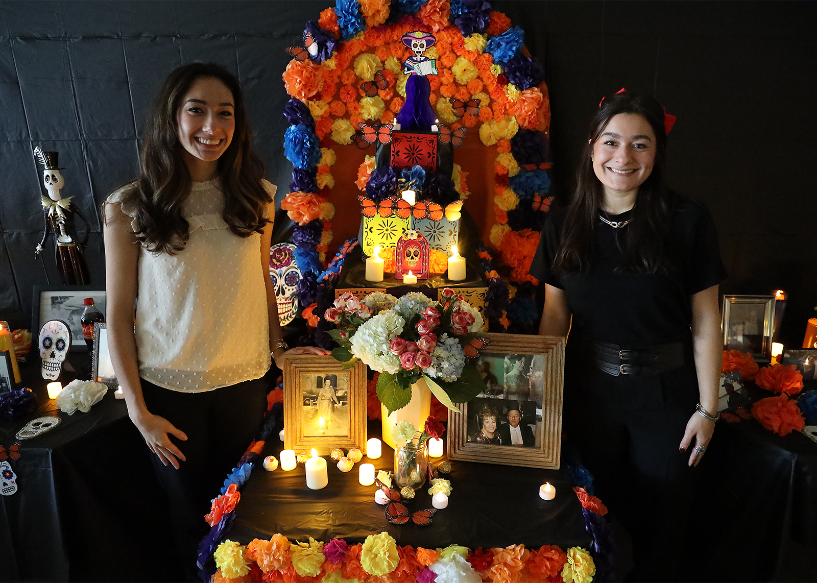 teacher and her sister in front of dias de los muerots alter