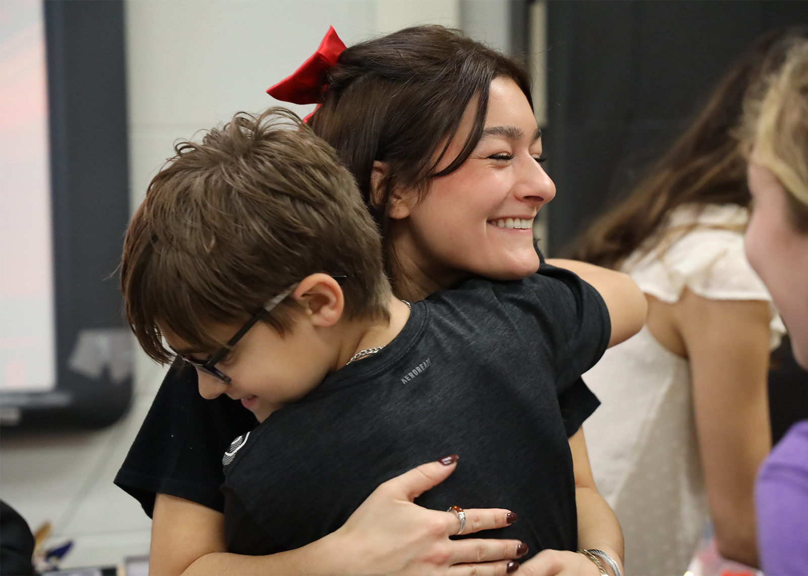 student hugs teacher 