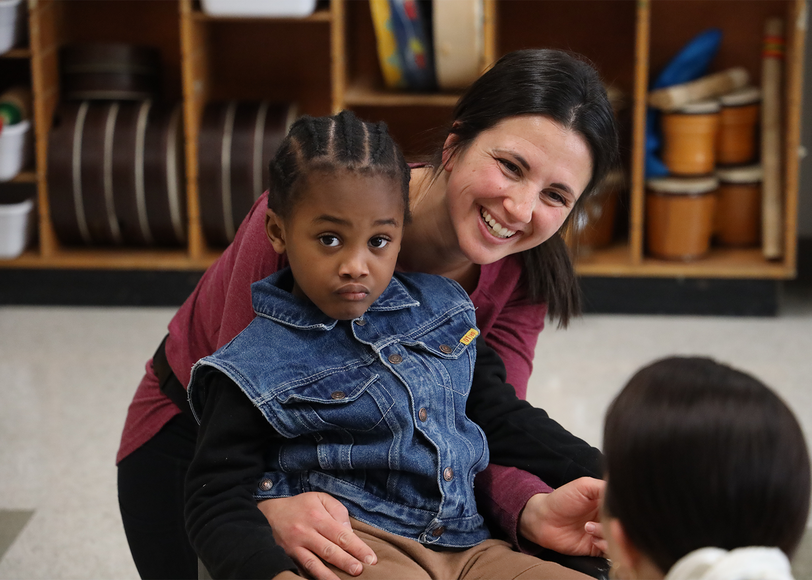 teacher sitting and smiling with a student