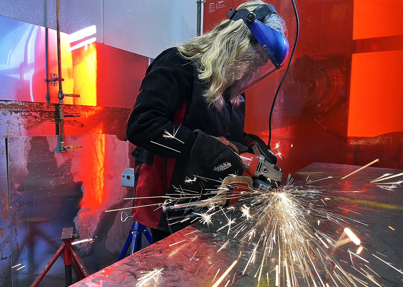 high school student makes sparks fly while welding