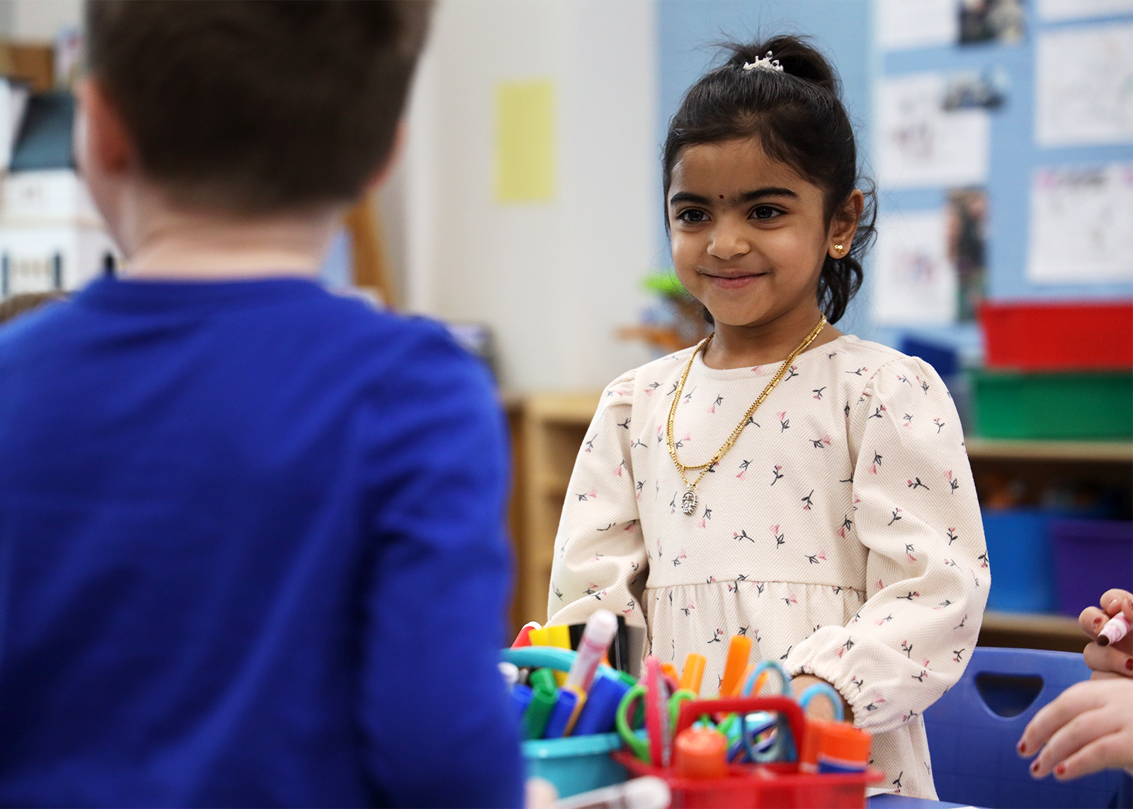 kindergartner smiling at classmate