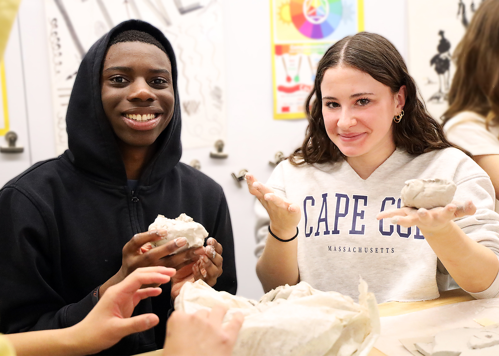 two middle school artists doing a clay project